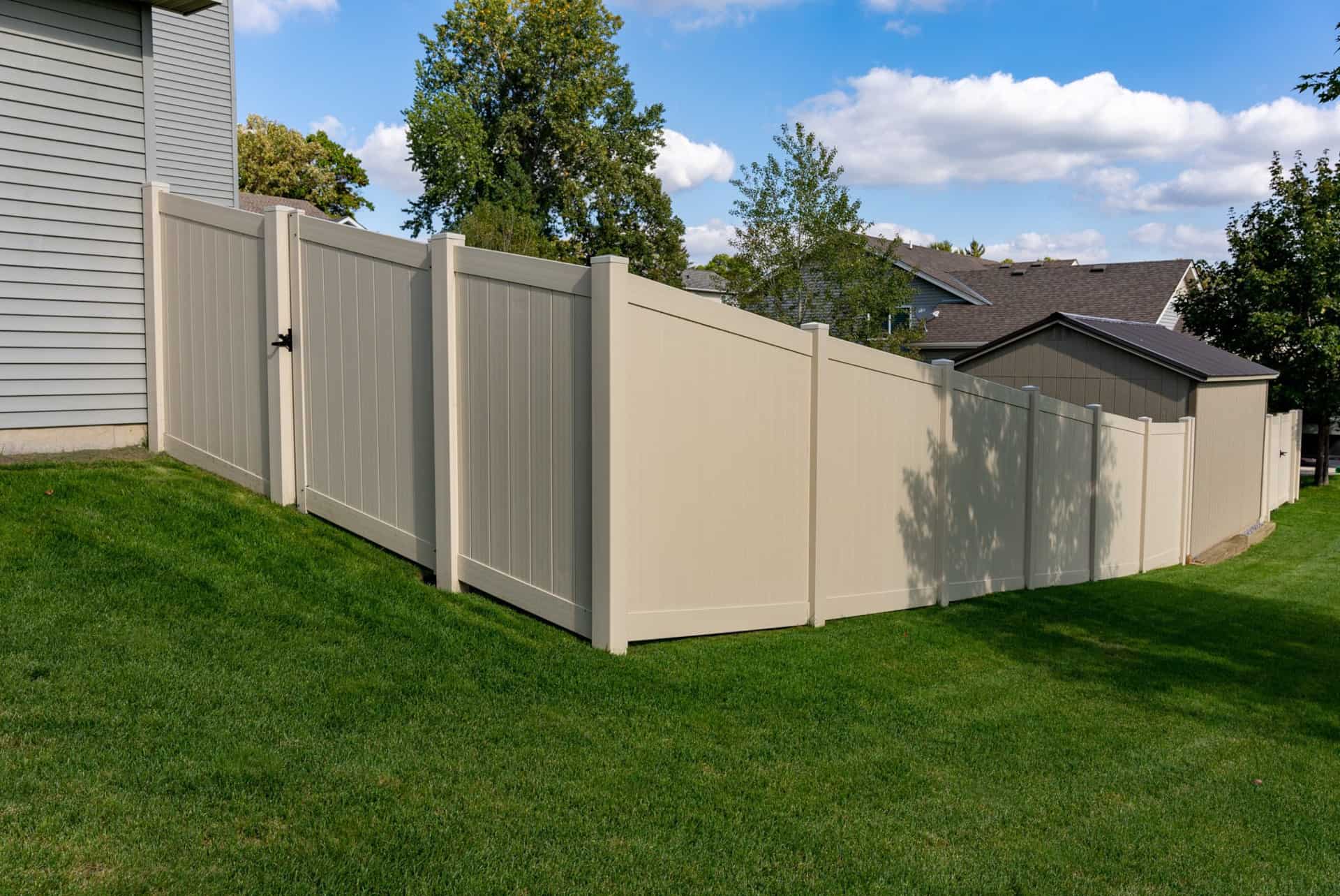fencing on a slope - tan vinyl privacy ramsey