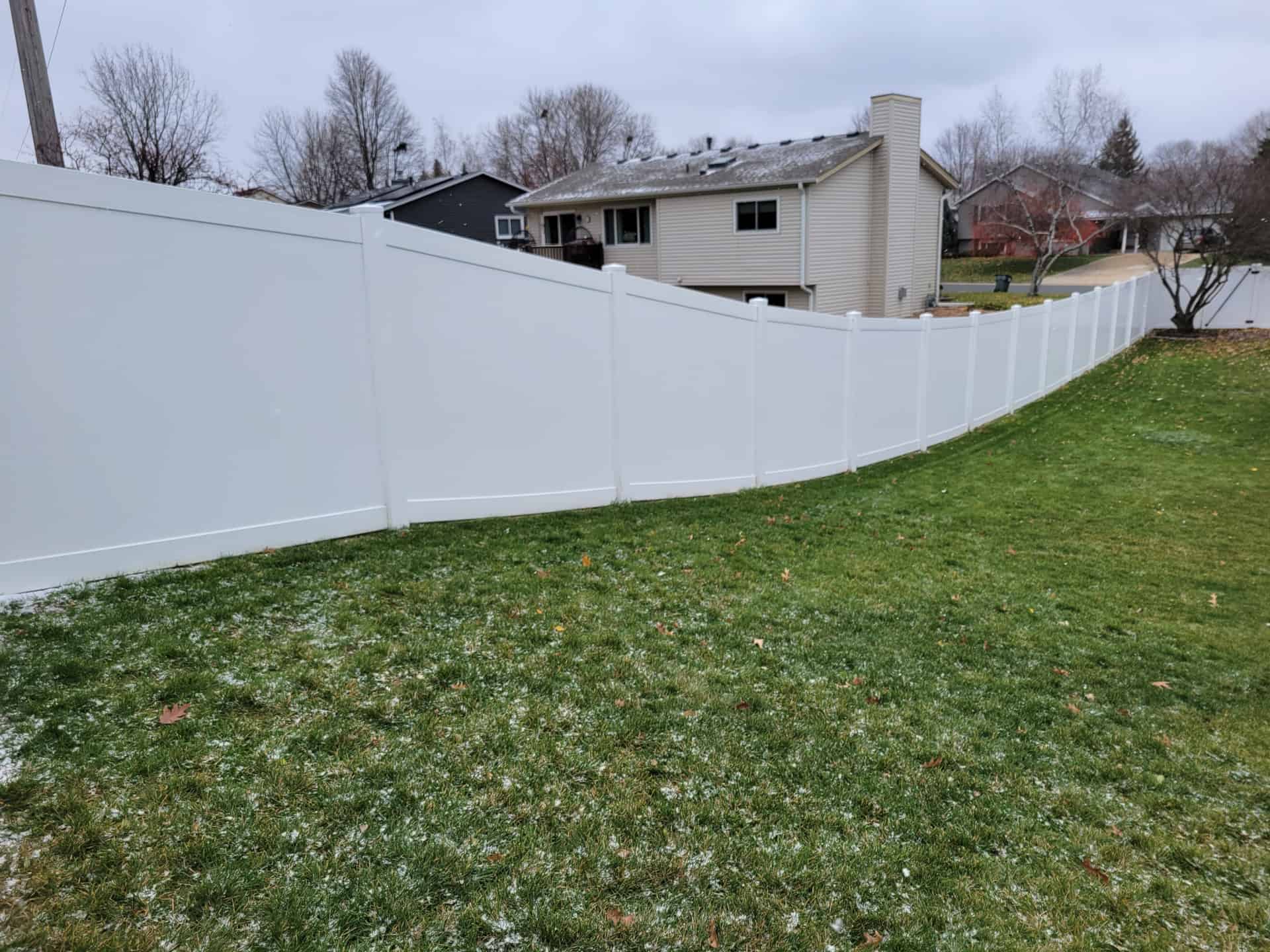 long white vinyl privacy fence on lotline
